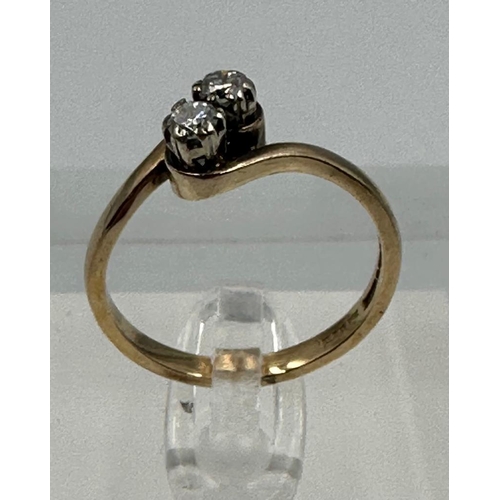 588 - A two stone diamond ring on a 9ct gold setting, approximate size P and weight 2.6g.