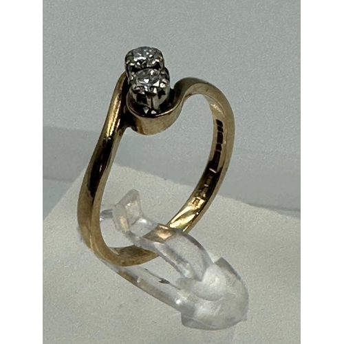 588 - A two stone diamond ring on a 9ct gold setting, approximate size P and weight 2.6g.