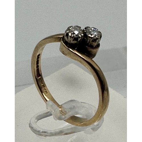 588 - A two stone diamond ring on a 9ct gold setting, approximate size P and weight 2.6g.