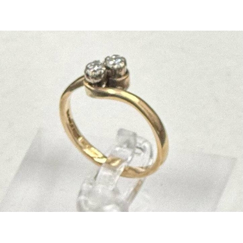 588 - A two stone diamond ring on a 9ct gold setting, approximate size P and weight 2.6g.