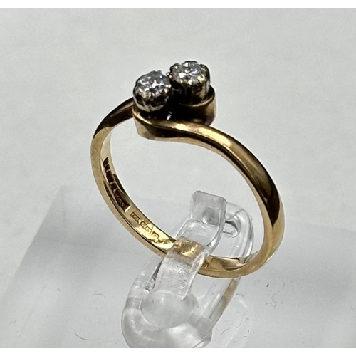 588 - A two stone diamond ring on a 9ct gold setting, approximate size P and weight 2.6g.