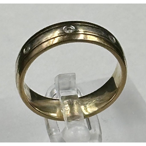 589 - A 9ct gold band with diamond insets, approximate total weight 4.3g and size N