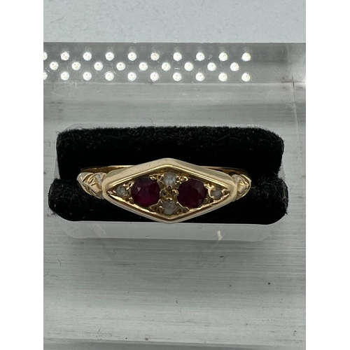 590 - An 18ct gold antique ring with inset rubies and ornate design, approximate total weight 2.1g and siz... 