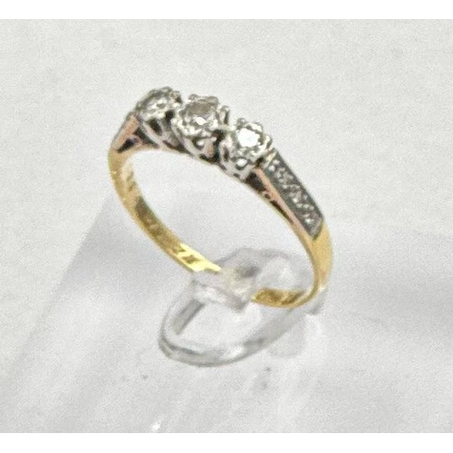 594 - An 18ct and platinum three stone diamond ring with diamond shoulders, size N1/2