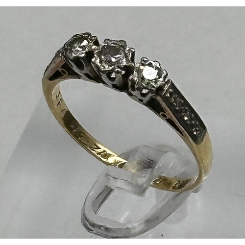 594 - An 18ct and platinum three stone diamond ring with diamond shoulders, size N1/2