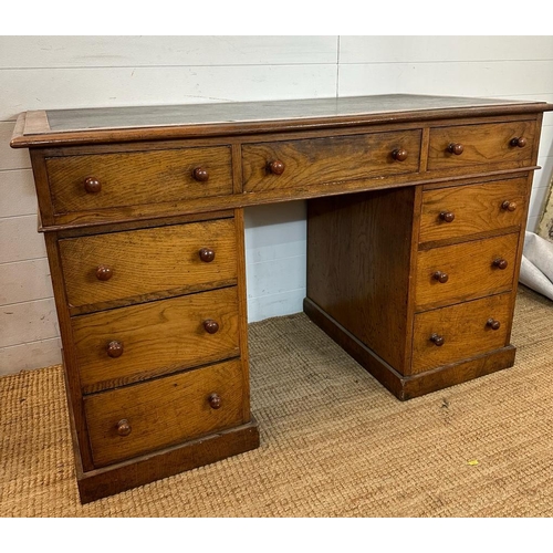 6 - An oak pedestal desk with long central drawer flanked by four shorter drawers to left and right(H75c... 