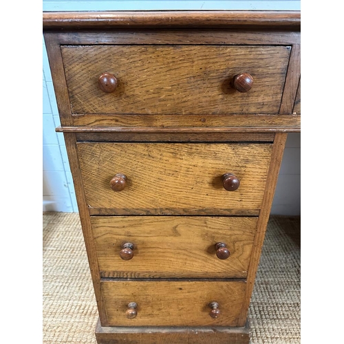 6 - An oak pedestal desk with long central drawer flanked by four shorter drawers to left and right(H75c... 