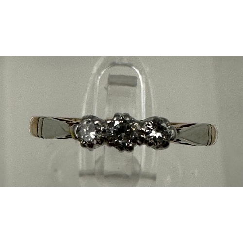 600 - A 9ct gold and platinum three stone diamond ring, size L.