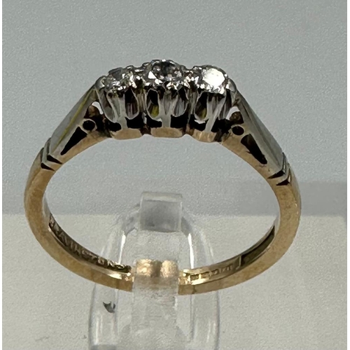 600 - A 9ct gold and platinum three stone diamond ring, size L.