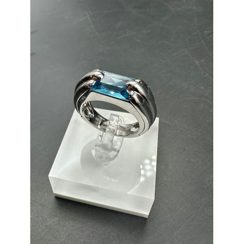 603 - A single stone Audemars Piguet ring consisting of a rectangular mixed cut blue topaz stone (12.1mm x... 