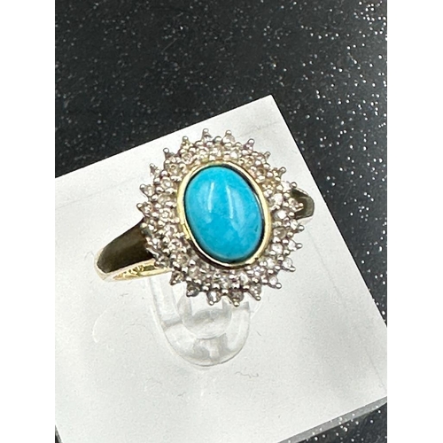 610 - A 9ct gold diamond and turquoise ring. (Approximate Total Weight 3.7g) Size P1/2