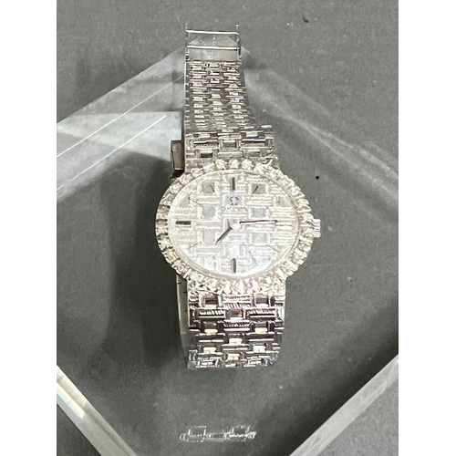 614 - A Ladies 18ct gold and diamond Omega watch, textured white dial, black hourly makers, a 17 jewel man... 