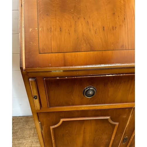 66 - A yew bureau bookcase comprising of a glazed two shelf bookcase and a red leather topped bureau with... 