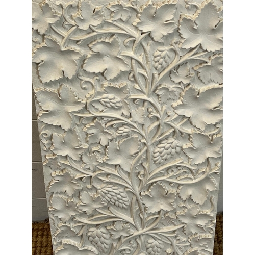 679 - A plaster plaque with floral pattern 64cm x 33cm