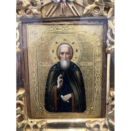 689 - A Russian icon in a glazed case 27cm x 36cm