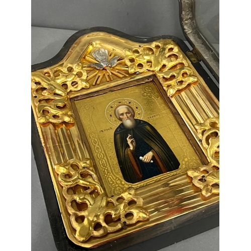 689 - A Russian icon in a glazed case 27cm x 36cm