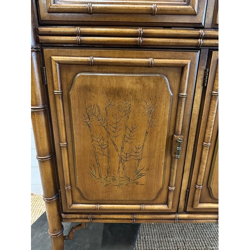 69 - A bamboo effect glazed cabinet with two glass shelves and three embossed cupboards under (H200cm W13... 