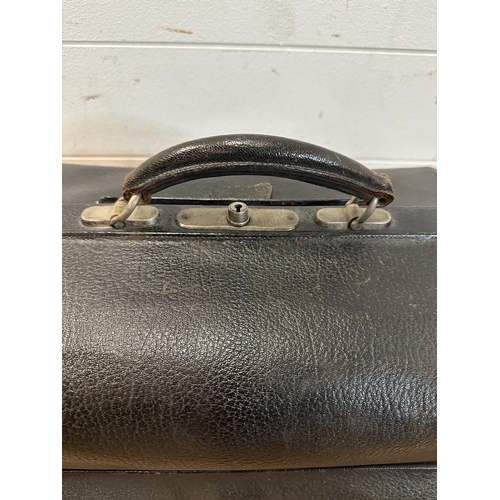 696 - A vintage black leather doctors bag