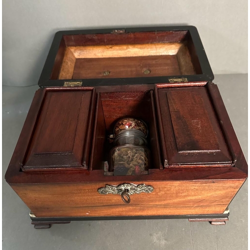 697 - A rosewood tea caddy on block feet with brass handle and key