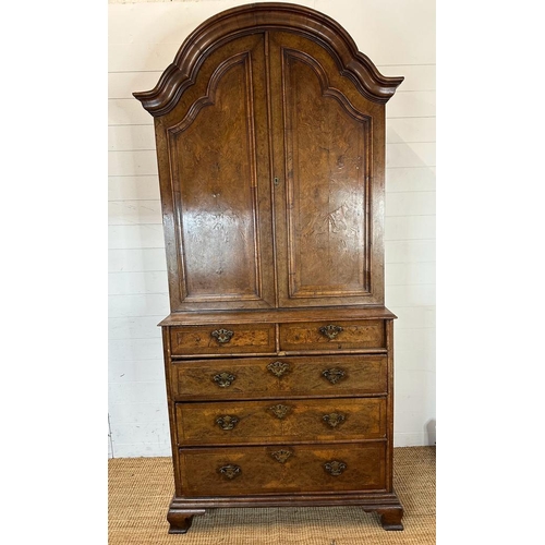 7 - A Queen Anne revival walnut panelled cabinet on two over three chest with block feet, brass handles ... 