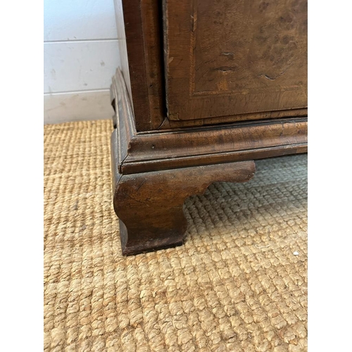 7 - A Queen Anne revival walnut panelled cabinet on two over three chest with block feet, brass handles ... 