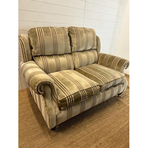 70 - A two seater Parker Knoll sofa upholstered in stripe greys and greens