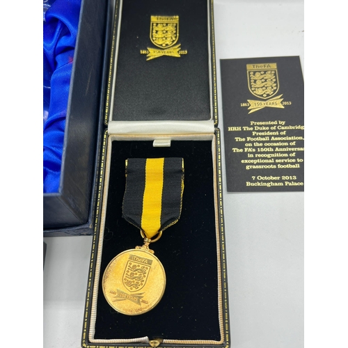 713 - A collection of FA medals and memorabilia items