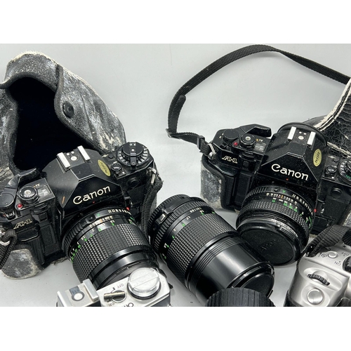 721 - Five cameras and lenses, various aged and makers including Olympus, Cannon etc