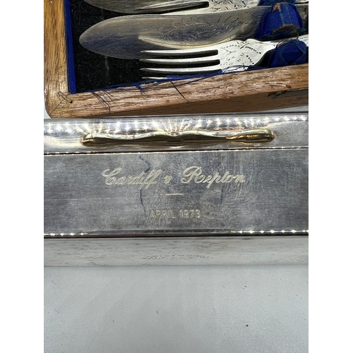 728 - A cased set of fish knives and forks along with a white metal cigarette case