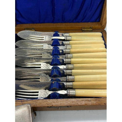 728 - A cased set of fish knives and forks along with a white metal cigarette case