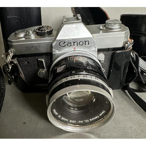 733 - A Canon FT QL 35mm camera and three extra lenses to include a Tamron telescope