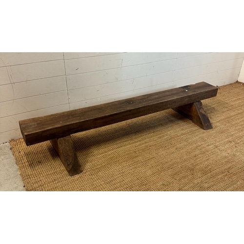 74 - A reclaimed oak bench on triangular feet (H30cm W180cm)