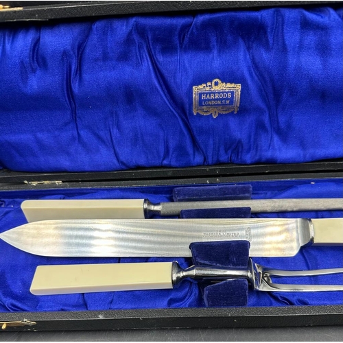 760 - A boxed stainless steel carving set from Harrods of London to include knife, fork and steel