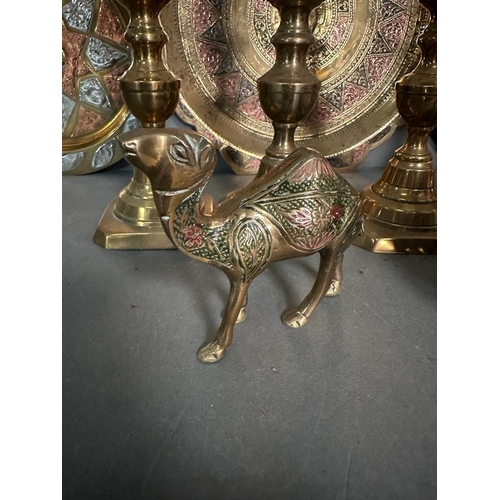 764 - A selection of brass items to include candlesticks, plates and an elephant claw bell