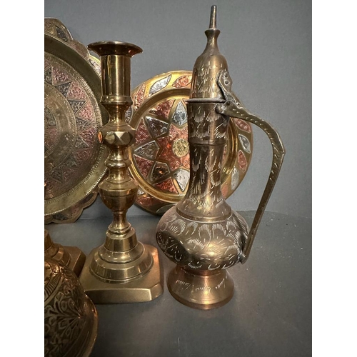 764 - A selection of brass items to include candlesticks, plates and an elephant claw bell