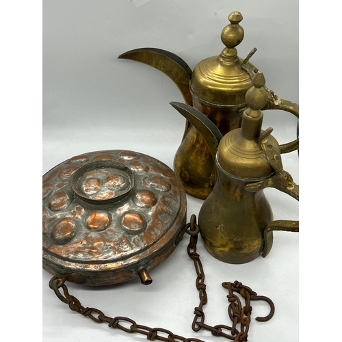 765 - Two Middles Eastern coffee pots and a copper flask/container on a chain