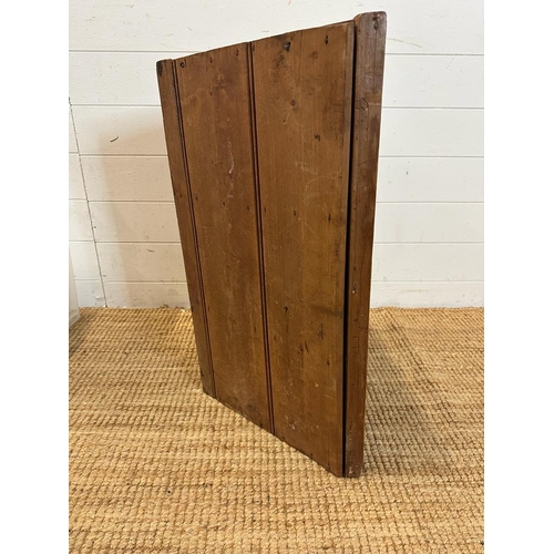 77 - A pine three door corner cupboard carved to front (H68cm W51cm D30cm)