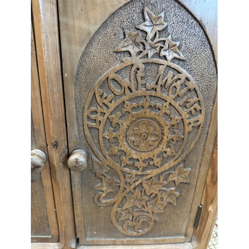 77 - A pine three door corner cupboard carved to front (H68cm W51cm D30cm)