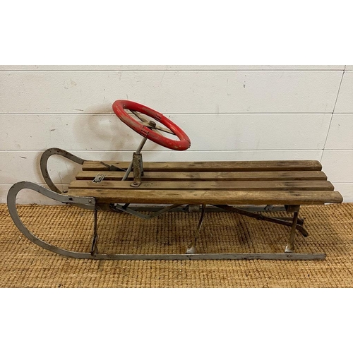 780 - A vintage Rojtos Childs sledge with red steering wheel