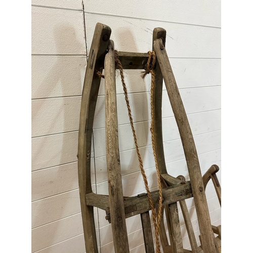 783 - Two vintage Bentwood sledges, one stamped 