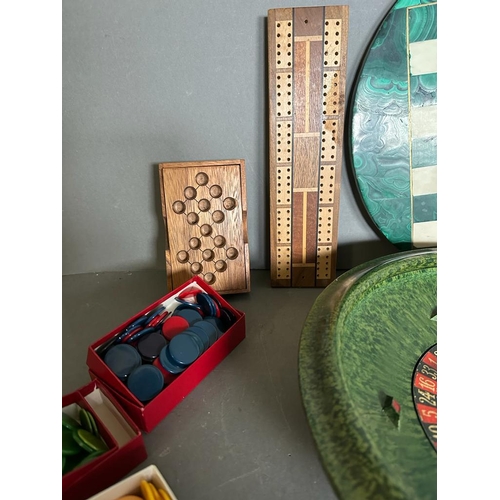 794 - A selection of games and gaming tokens to include chess board and pieces, cribbage board and a roule... 