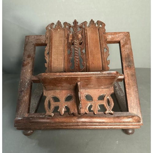 82 - A vintage wooden book or bible stand with carved central plinth