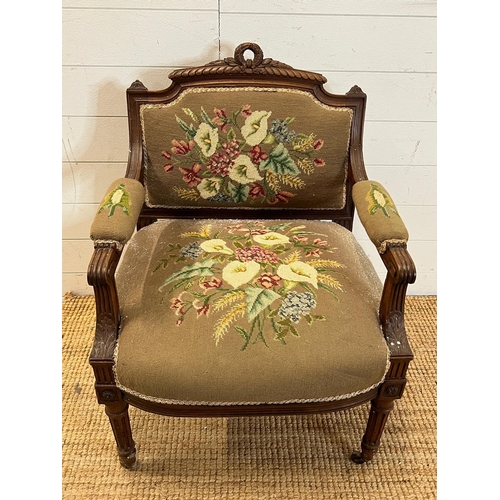 85 - A needle work upholstered Easy chair with carved top rail and fluted down swept arms