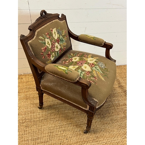 85 - A needle work upholstered Easy chair with carved top rail and fluted down swept arms