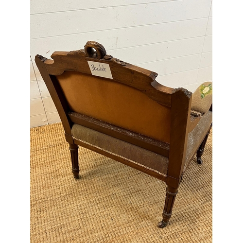 85 - A needle work upholstered Easy chair with carved top rail and fluted down swept arms