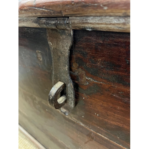 86 - A large wooden chest with wrought iron lock on wooden feet (H70cm W121cm D60cm)