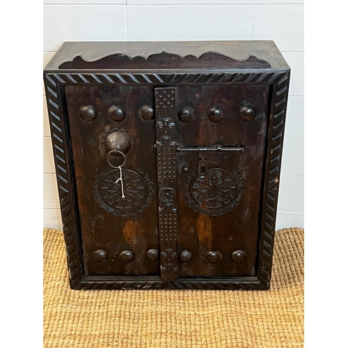 87 - An oak hobnail wall cabinet with carved boarder (H69cm W56cm D28cm)