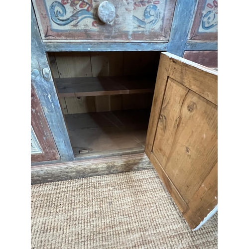 90 - A vintage pine sideboard comprising of three drawers and three cupboards under with painted floral d... 