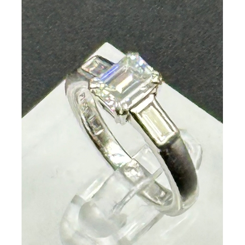 555A - Diamond ring with centrally set emerald cut diamond, approx 6.48mm x 5.03mm x 3.34mm, stated weight ... 