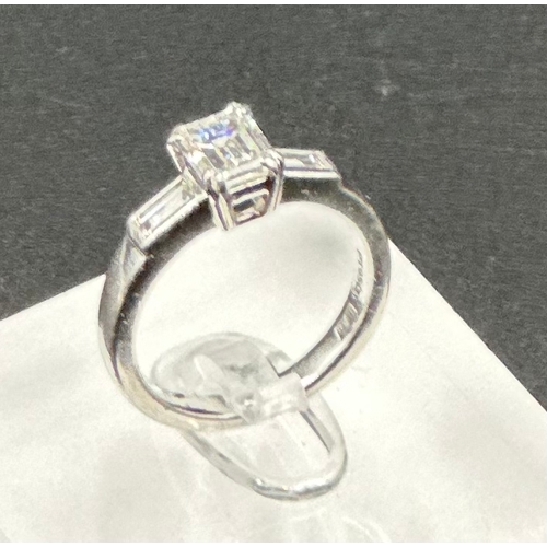 555A - Diamond ring with centrally set emerald cut diamond, approx 6.48mm x 5.03mm x 3.34mm, stated weight ... 